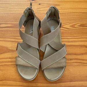 Neutral colored sandals.